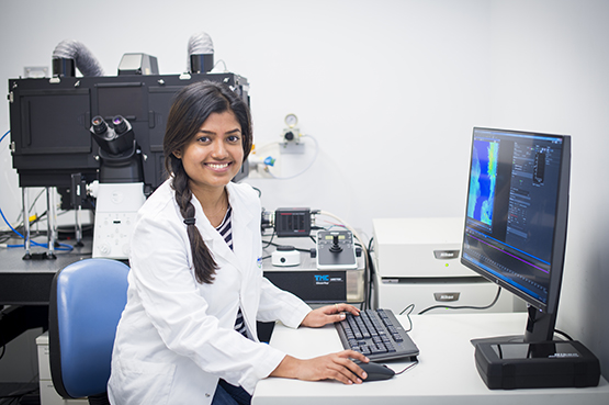 Female scientist at a microscope